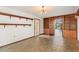 Living room with tile floors, built in wood shelves, and an open door to another room at 1450 Harbour Dr, Longwood, FL 32750