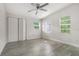 Cozy bedroom featuring gray wood-look floors, a ceiling fan, and a closet at 1506 37Th St, Orlando, FL 32839
