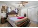 Bedroom with wood flooring, large bed, closet, and ceiling fan at 1506 37Th St, Orlando, FL 32839