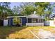 Charming single-story home with navy blue siding, white trim, and a cozy screened-in front porch at 1506 37Th St, Orlando, FL 32839