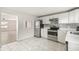 Updated kitchen with white cabinets, stainless steel appliances, and modern tile flooring at 1506 37Th St, Orlando, FL 32839