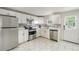 Well-appointed kitchen with stainless steel appliances, white cabinetry, and stylish backsplash at 1506 37Th St, Orlando, FL 32839
