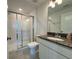 Modern bathroom features a walk-in shower, granite countertop, and ample cabinet space at 15098 Windflower Aly, Winter Garden, FL 34787