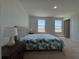 Spacious bedroom with a large bed, two windows providing plenty of natural light at 15098 Windflower Aly, Winter Garden, FL 34787