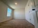 Carpeted bedroom with bright window, neutral walls and interior door at 15098 Windflower Aly, Winter Garden, FL 34787