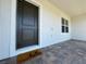 Close-up of the front door with brick pavers, showcasing a dark door and the home's exterior details at 15098 Windflower Aly, Winter Garden, FL 34787