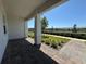 Covered front porch featuring brick pavers, white support columns and landscaping at 15098 Windflower Aly, Winter Garden, FL 34787