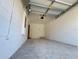 View of garage with bright white painted block and concrete floors at 15098 Windflower Aly, Winter Garden, FL 34787