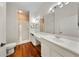Bright bathroom featuring a double vanity, hardwood floors, and walk-in shower at 1630 Common Way Rd # 303, Orlando, FL 32814