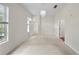 Spacious bedroom featuring large windows, neutral carpeting, and stylish light fixture at 1630 Common Way Rd # 303, Orlando, FL 32814