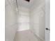 Walk-in closet features built-in shelving for optimal organization and storage at 1630 Common Way Rd # 303, Orlando, FL 32814
