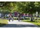 Scenic community pathway with mature trees and residents enjoying an active lifestyle on bicycles at 1630 Common Way Rd # 303, Orlando, FL 32814