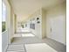 Wide hallway with bright natural light leads to unit 303 with white door and sconce at 1630 Common Way Rd # 303, Orlando, FL 32814