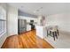 Modern kitchen features white cabinets, stainless steel appliances, and a stylish breakfast bar at 1630 Common Way Rd # 303, Orlando, FL 32814