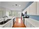 Updated eat-in kitchen with black appliances, tile backsplash, and breakfast bar at 1630 Common Way Rd # 303, Orlando, FL 32814