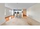 Open concept living room with carpet, wood floors, and a cozy breakfast bar at 1630 Common Way Rd # 303, Orlando, FL 32814