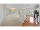Open-concept living room with carpet, wood flooring, and doors leading to the outside at 1630 Common Way Rd # 303, Orlando, FL 32814