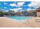 Community pool offers residents a recreational swimming option with surrounding lounge chairs and landscaping at 1630 Common Way Rd # 303, Orlando, FL 32814