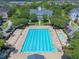 Aerial view showcases a community pool with a recreational area and ample seating for residents' enjoyment at 1630 Common Way Rd # 303, Orlando, FL 32814