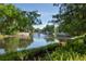 Picturesque water view featuring a serene lake and charming bridge embraced by lush greenery at 1630 Common Way Rd # 303, Orlando, FL 32814