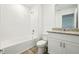 Clean bathroom with white tile, bathtub, and granite vanity at 16447 Bird Of Paradise Ave, Clermont, FL 34714
