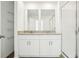 Stylish bathroom features double sinks with granite counters and a glass-enclosed shower at 16447 Bird Of Paradise Ave, Clermont, FL 34714
