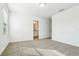 Bedroom features neutral carpet and a view to a bathroom at 16447 Bird Of Paradise Ave, Clermont, FL 34714