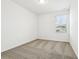 Bright bedroom features neutral carpet, white walls, and a window providing natural light at 16447 Bird Of Paradise Ave, Clermont, FL 34714