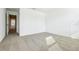 A bright bedroom with neutral carpet, white walls, and lots of natural light at 16447 Bird Of Paradise Ave, Clermont, FL 34714