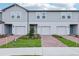 Charming townhomes feature brick driveways and beautifully landscaped front yards at 16447 Bird Of Paradise Ave, Clermont, FL 34714