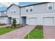 New townhome boasts brick paver driveway, landscaping, and stylish facade at 16447 Bird Of Paradise Ave, Clermont, FL 34714