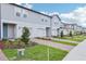 New townhome features brick paver driveway, green space, and appealing facade at 16447 Bird Of Paradise Ave, Clermont, FL 34714