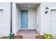 Charming front porch with brick pavers and a blue front door at 16447 Bird Of Paradise Ave, Clermont, FL 34714