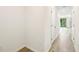 Hallway leading to a bright living area with tile flooring at 16447 Bird Of Paradise Ave, Clermont, FL 34714