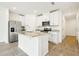 Modern kitchen features stainless steel appliances and a large island at 16447 Bird Of Paradise Ave, Clermont, FL 34714