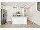 Well-lit kitchen boasts a center island with stainless steel appliances and granite countertops at 16447 Bird Of Paradise Ave, Clermont, FL 34714