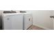 Laundry room with modern white washer and dryer at 16447 Bird Of Paradise Ave, Clermont, FL 34714