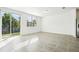 Bright living room featuring tile floors and sliding glass doors to backyard at 16447 Bird Of Paradise Ave, Clermont, FL 34714