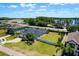 Stunning aerial view of home with solar panels, screened pool, and large backyard bordered by a white fence at 17106 Guilford Ct, Orlando, FL 32820