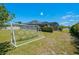 Manicured backyard features a soccer net and screened in pool at 17106 Guilford Ct, Orlando, FL 32820