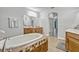 Bright bathroom features a soaking tub with decorative tile, wooden vanities, and stylish finishes at 17106 Guilford Ct, Orlando, FL 32820