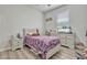 Charming bedroom with a colorful bedspread, neutral walls, and a bright window at 17106 Guilford Ct, Orlando, FL 32820