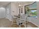 Cozy breakfast nook with backyard view, modern chandelier and seating for four, perfect for casual meals at 17106 Guilford Ct, Orlando, FL 32820