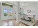 Elegant dining area featuring double doors, tile entryway and seating for eight, ideal for Gathering dinners at 17106 Guilford Ct, Orlando, FL 32820