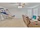 A cozy game room provides a fun space with a leather couch, basketball game, and neutral carpet at 17106 Guilford Ct, Orlando, FL 32820