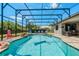 Sparkling screened-in pool with waterfall feature, lounge chairs and patio area perfect for outdoor entertaining at 17106 Guilford Ct, Orlando, FL 32820