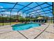 Beautiful screened pool with lush landscaping and a waterfall feature at 17106 Guilford Ct, Orlando, FL 32820
