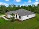 Beautiful aerial of a modern single-story home with manicured lawn and natural surroundings under a bright blue sky at 18026 Reynolds Pkwy, Orlando, FL 32833