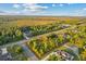 Aerial view of a vacant lot bordered in red, surrounded by mature trees, and a paved street at 18026 Reynolds Pkwy, Orlando, FL 32833