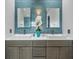 Bathroom featuring double sinks, stylish blue tile backsplash, and modern fixtures at 18026 Reynolds Pkwy, Orlando, FL 32833